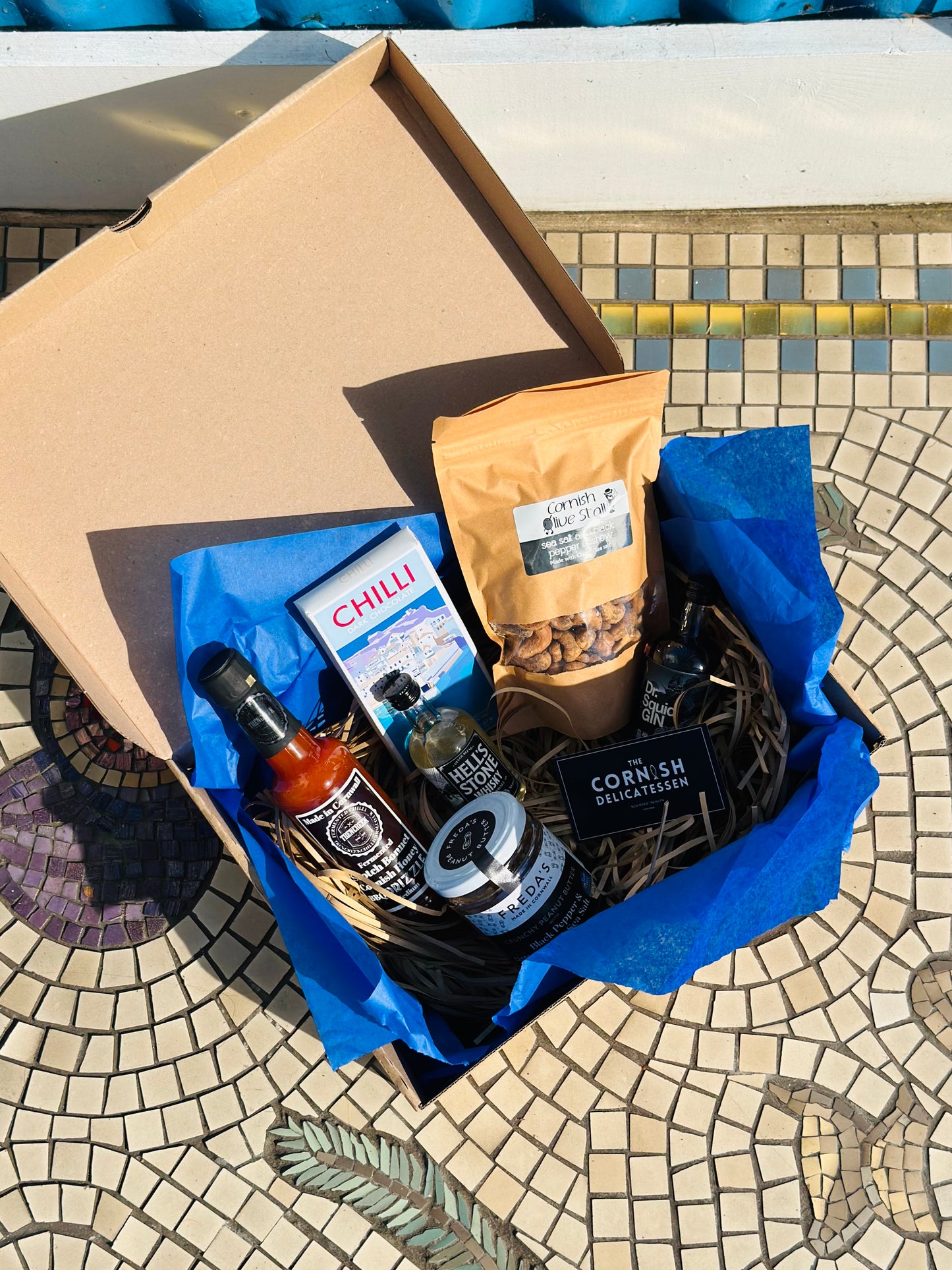 Hot Stuff gift box, including chilli chocolate, mini gin and whisky, salt and pepper peanut butter and a hot sauce.