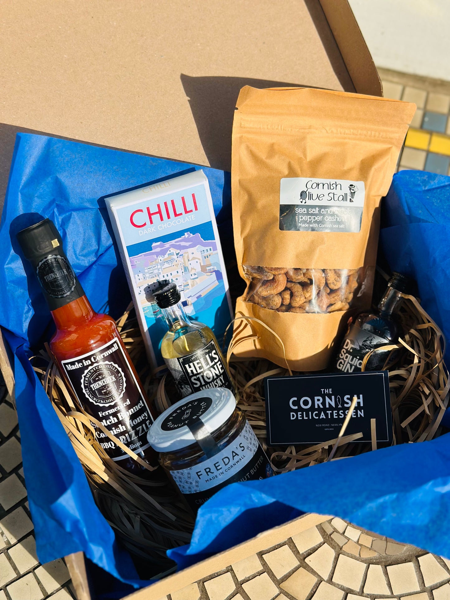 Hot Stuff gift box, including chilli chocolate, mini gin and whisky, salt and pepper peanut butter and a hot sauce.