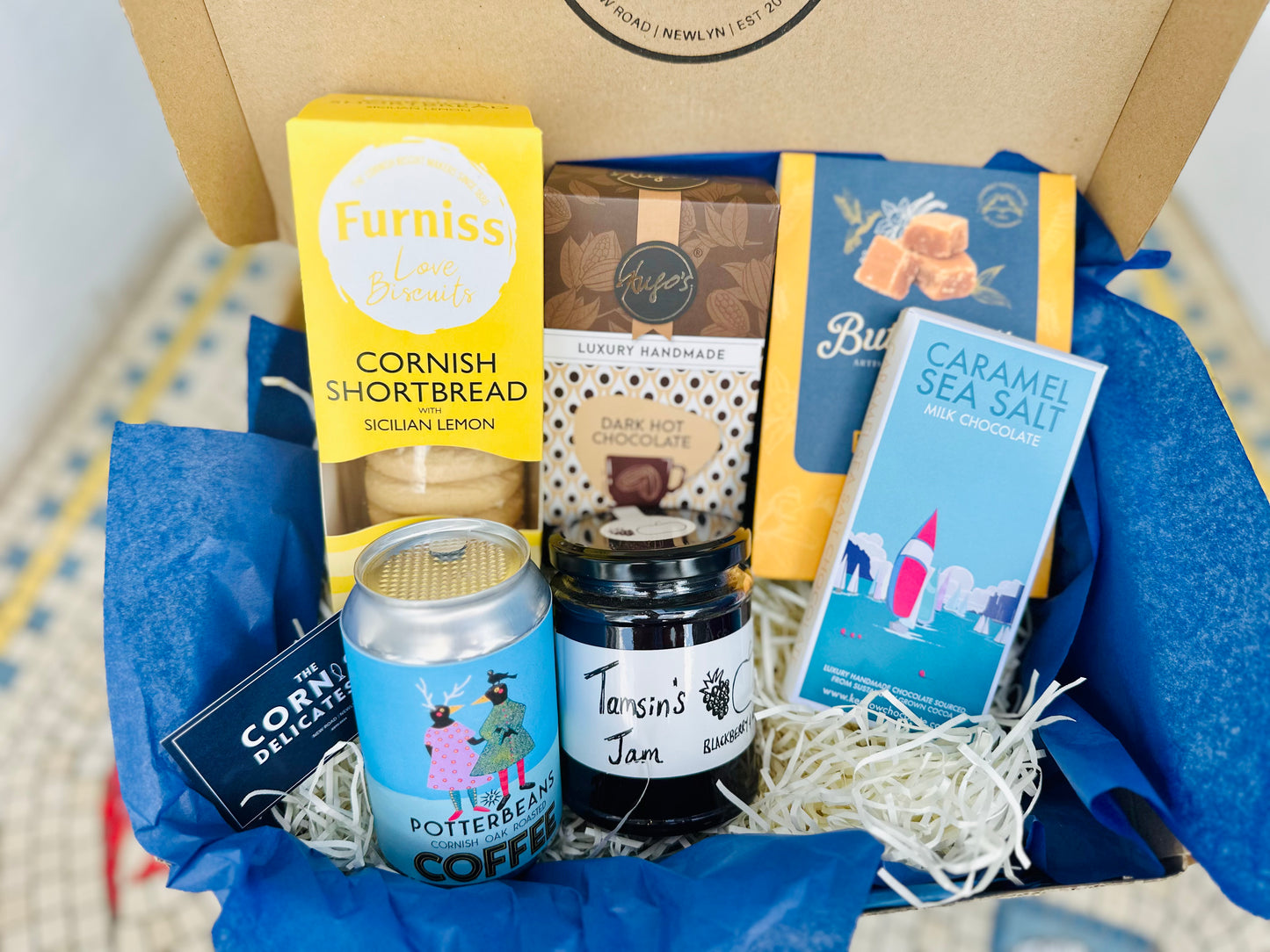 Sweet Treats gift box, including a bar of chocolate, biscuits, hot chocolate, jam, coffee beans and fudge.
