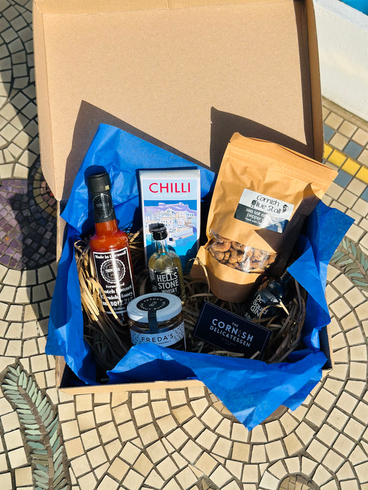 Hot Stuff gift box, including chilli chocolate, mini gin and whisky, salt and pepper peanut butter and a hot sauce.