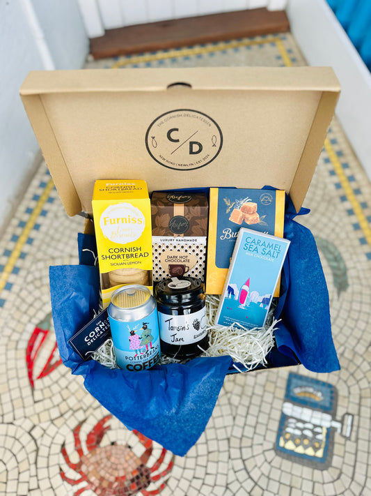 Sweet Treats gift box, including a bar of chocolate, biscuits, hot chocolate, jam, coffee beans and fudge.